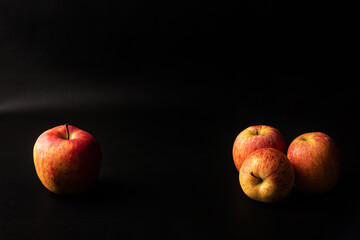 Fototapeta na wymiar Apples, beautiful apples arranged over black background, Low Key portrait, selective focus.