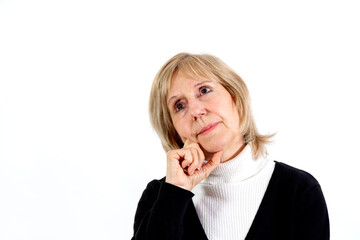 Elderly woman in thinking position with the hand on the face. White background. Around 65 years woman.