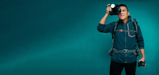 Happy traveler with a camera and blue background