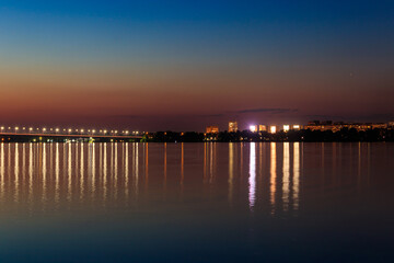 Fototapeta na wymiar Night view of the Dnieper river and Dnipro city in Ukraine