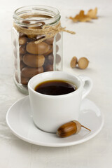 Acorn coffee and acorns in a glass jar. Healthy no caffeine beverage