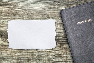 Blank paper on wooden background. Christian biblical concept of belief in God Jesus Christ.