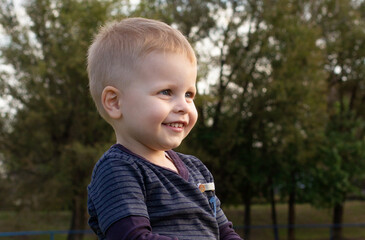 Cute boy enjoying the outdoors in a home yard setting.