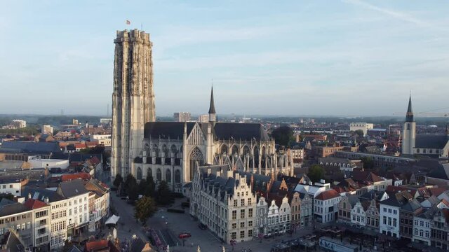 
Aerial drone shot of Mechelen Saint Rumbold's Cathedral Sint Rombouts toren in a lovely morning light while birds are flying around
