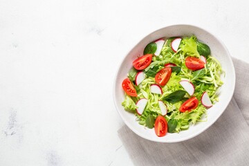 Vegetarian fresh salad. Healthy food, diet lunch. Top view on a white background.