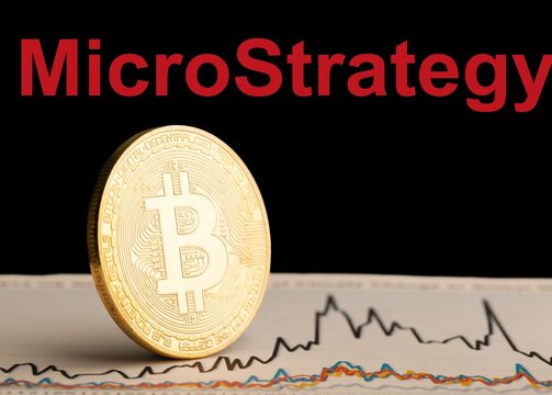 Bitcoin BTC representation coin with MicroStrategy text in background.