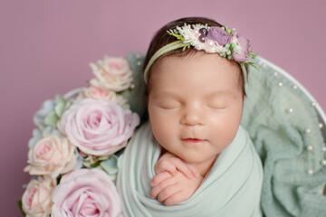 Fototapeta na wymiar Newborn girl on a pink background. Photoshoot for the newborn. 