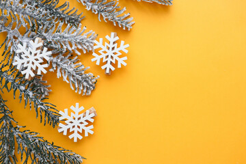 christmas card mockup. frame from fir branches and snowflakes on a yellow background. congratulation. invitation 