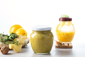 Jar with honey and lemon on a white background. Ginger and lemon, grated with honey. Jam on a white background.