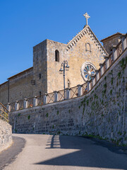 view to medieval church under blue sky in italian city Bolsena