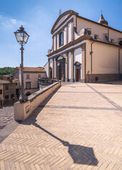 street lighter with shadow and view to theatre in city Gradoli in Italy in summer day