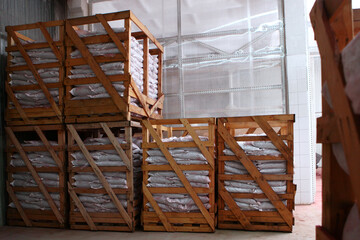 Warehouse interior. Wooden shelving. Bags in racks in the warehouse.Storage of bulk products in bags.