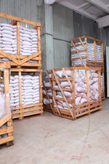 Warehouse interior. Wooden racks. The packages are in the racks in the warehouse.Storage of bulk products in bags. Storing food in large quantities.