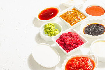 Set of different sauces - ketchup, mayonnaise, barbecue, soy, chutney, wasabi, adjika, horseradish