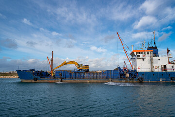 Dredger ship in work.