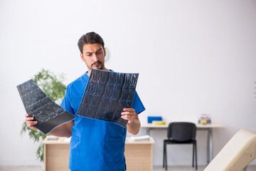 Young male doctor radiologist sitting in the clinic