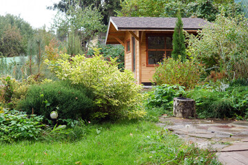 house in the garden. green bushes in summer