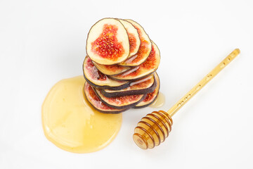 figs cut into pieces and drizzled with honey on a white plate. vitamin organic healthy food