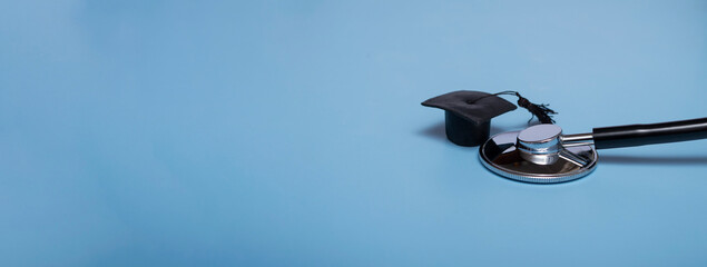 Stethoscope and graduate hat, on a blue background, top view, medical background graduate achievement, background, banner