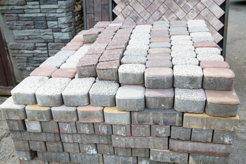 A stack of oval and rectangular paving stones of light lilac, beige color. Texture backgrounds for wallpaper graphics design