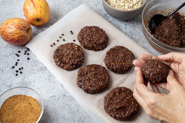 Process of preparation of chocolate oatmeal cookies. Homemade vegan dessert. Healthy eating concept.