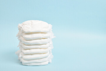 A stack of disposable panties on a blue background. A place to copy.