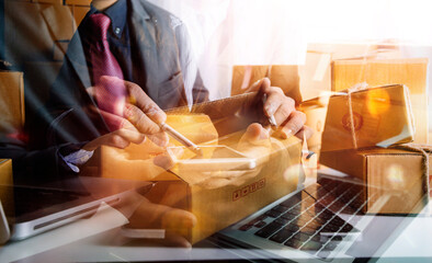 Young woman small business owner online shopping at home. taking note of orders from customers with mobile phones. SME entrepreneur or freelance life style concept.