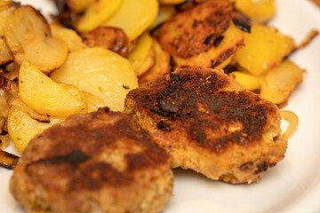 Meatballs with fried potatoes in the pan