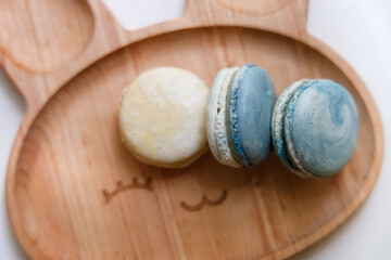 macarons, beautiful macarons with cheese, confectionery, almond and nut biscuits, macarons on a plate, sweets, dessert, cake, man takes macarons