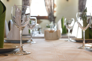 Empty glasses are on the table. A fragment of the serving.