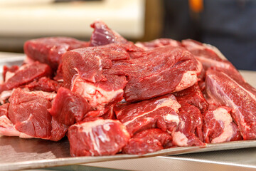 Fototapeta premium Pieces of raw sliced meat on a cutting board. The concept of trade in meat products.