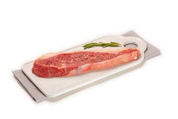 filete de lomo de ternera fresco y crudo sobre un plato blanco y una servilleta de tela gris, aislada fondo blanco