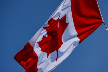 The national flag of Canada waving in the breeze from a boat mast on a summer's day