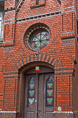 Fototapeta na wymiar Entrance to an old red brick building