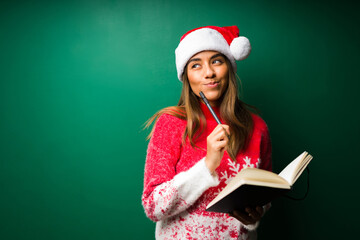 Smart woman writing on a notebook on Christmas