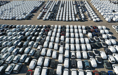 Fototapeta premium Aerial view from drone to automobile customs terminal. Large number of cars at customs terminal are awaiting shipment. Accumulative customs platform for cars.