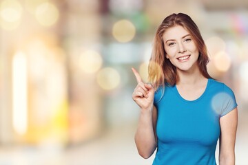 Happy lady smiling, pointing and looking with surprised face, standing