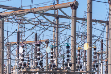 Fragment of a power plant. High-voltage equipment: various insulators, cables.