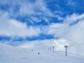 Image of a snow covered mountain plateau. Tourists walk and take pictures on a mountain plateau.