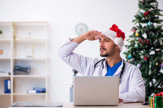 Young male doctor celebrating Christmas at the hospital
