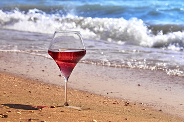 Wine glass with a cocktail by the sea.