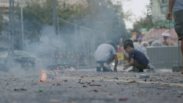 Children and exploding firecracker on Las Fallas, Spain
