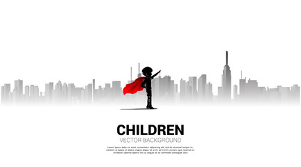 Silhouette of boy in superhero suit point to sky in city. Concept of education start and future of children.
