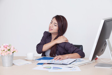 Woman has shoulder pain while working, office syndrome concept.