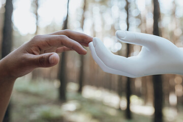 Hands of woman and robot touching