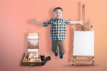 Photo of artist painter boy jump on an easel background