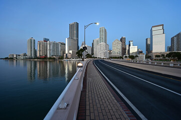 Fototapeta na wymiar Brickell Key Bridge and City of Miami skyline in pre dawn twilight on calm clear summer morning.