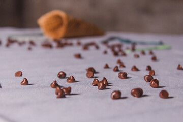 Obraz na płótnie Canvas Chocolate chips for ice cream spread on a white table.