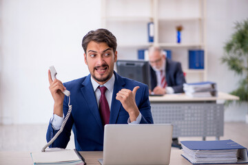 Two male colleagues working in the office