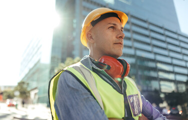 Blue collar worker looking thoughtful in the city